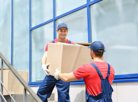 Boxes and furniture being loaded into a moving truck