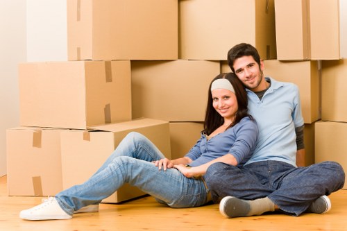 Removalists loading furniture into a truck in an inner-city area